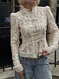Blusa de encaje con lazadas y cuello mao