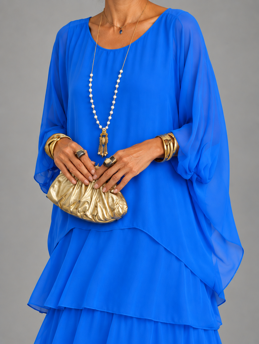 Vestido maxi con capa y falda de volantes