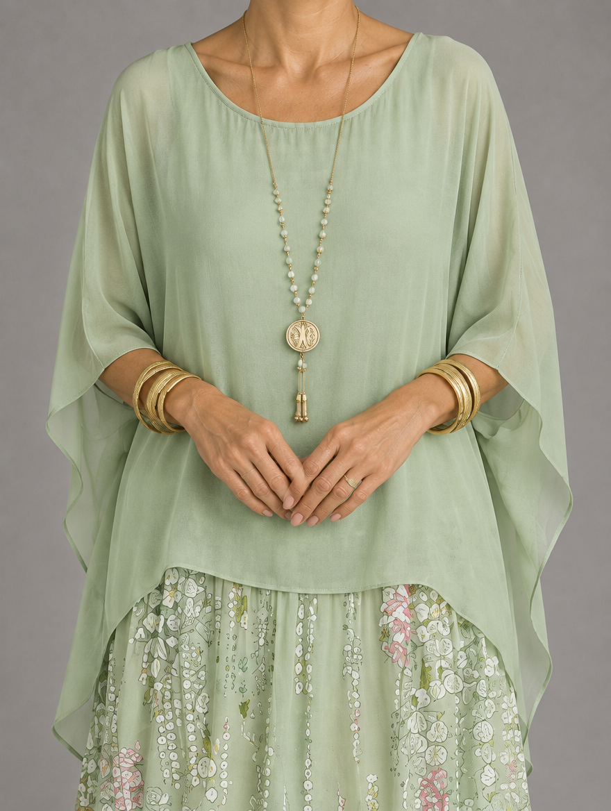 Vestido maxi con capa y falda de volantes